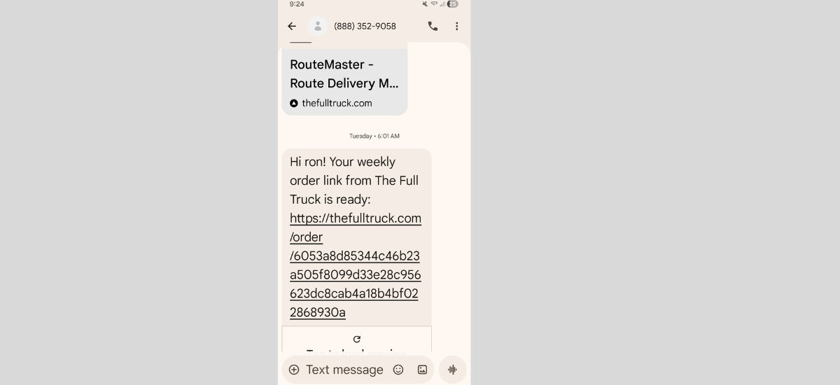 Text message on phone showing order link sent to customer